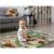 Baby sitting on Ricokids Premium washable play mat with zoo design