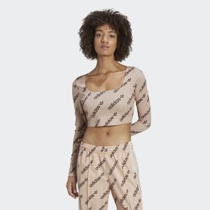 Adidas beige long sleeve crop top with logo print worn by a model, front view - Adidas Women's Sweater