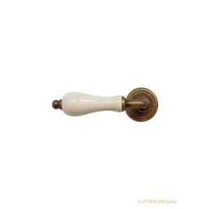 Antique white ceramic door handle with brass accents - Door