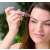 Woman using eyebrow trimmer, eyebrow shaper, eyebrow hair remover, rose gold, white, compact, cordless, battery operated, LED light