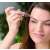 Woman using eyebrow trimmer, eyebrow shaper, eyebrow hair remover, rose gold, white, compact, cordless, battery operated, LED light