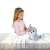 Girl playing with Club Petz Silver interactive plush baby seal toy, gray