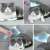 Collage of a cat being brushed with the blue and white cat shaped pet brush with handle