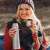 Woman holding a stainless steel thermos, silver, 500ml, double-walled, keeps drinks hot or cold for 24 hours, in autumn setting