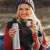 Woman drinking from a stainless steel thermos in the forest