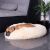 Dog resting in a Springos cream plush donut bed