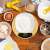 Emeszon® digital kitchen scale with flour in a bowl, surrounded by baking ingredients