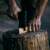 Man sharpening an axe with Fiskars Norden axe and knife sharpener