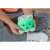 Child holding Luna the Calming Kitty night light, showing the light glowing green