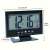 Digital alarm clock with LCD display, showing time, date, and temperature, with dimensions