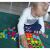 Girl playing with Gyermek Puzzle - Gomb Mozaik, developing fine motor skills