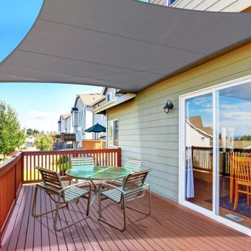 Gray shade sail over patio with outdoor furniture