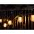 Kertészeti Branda 10 LED E27 10m string lights with warm white bulbs, hanging on a fence