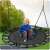 Child sitting on Neo-Sport SWINGO Nest Swing 120cm - Black