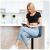 Woman sitting on Sofotel Drava blue bar stool in kitchen
