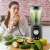 Femeie care bea un smoothie făcut cu blenderul Berdsen BD-751