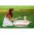 Baby in Ricokids pink and white bathtub with mother in garden
