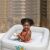 Baby enjoying bath time in Bestway inflatable tub, square infant tub