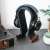 Navaris headphone stand with wooden base, black, in use