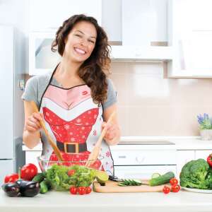 Woman wearing a Christmas themed apron, cooking in the kitchen - Apron