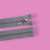 Gray zipper with metal slider, 50 cm long, on pink background