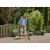 Woman using Gardena EasyWeed cordless joint cleaner