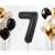 Black number 7 foil balloon with other balloons in the background