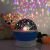Blue Night Sky Projector with teddy bear, creating a starry atmosphere