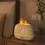 RetroFlame aroma diffuser with flame effect on a nightstand