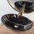 Pamela black marble effect oval washbasin with gold faucet and round mirror