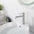 Rea Foss brushed nickel bathroom faucet on white sink