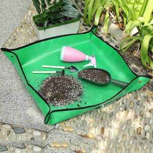 Green gardening mat with tools, soil, and a pink watering can - Gardening Film