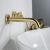 Rea Lungo matte gold faucet filling a washbasin
