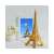 Puzzle 3D din metal Piececool, Turnul Eiffel, 96 de piese, auriu, pe o masă cu flori