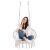 Woman sitting in Springos macrame hanging chair on white background