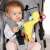 Baby playing with Fehn Dinosaur Activity Center in stroller