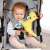 Baby playing with Fehn Dinosaur Activity Center in stroller