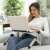 Woman using InnovaGoods Omnible adjustable laptop desk on the couch