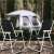 Springos folding chairs, black, white frame, two chairs shown, unfolded, camping setting