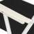 Springos folding chair, black, white frame, close-up of armrest