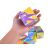 Child's hand holding dinosaur cube puzzle