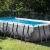 Intex rectangular frame pool with solar cover and roller in garden setting