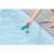Hand putting Bestway Flowclear floating chemical dispenser for pool into the water