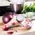 Snips onion saver in use, red onion shaped plastic container for storing cut onions, keeps onions fresh, kitchen counter