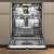 Whirlpool W8I HF58 TU built-in dishwasher, open door, interior view, showing upper and lower racks