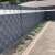 Gardlov fence tape, black, installed on a fence in a garden