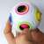 Hand holding a magic ball puzzle toy, colorful, white, 6.5 cm