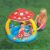 Baby playing in Gomba mushroom-themed inflatable baby pool with sunshade