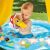 Child playing in Gomba mushroom-themed inflatable baby pool with sunshade