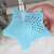 Blue silicone star shaped drain strainer, catching food scraps in a sink